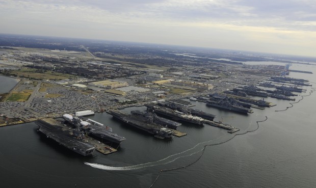 Six amphibious ships and five carriers moored in Norfolk.